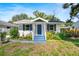 Charming single-story home with a blue front door, white siding, and lovely landscaping at 716 35Th W St, Bradenton, FL 34205