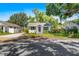 Charming single-story home with a blue front door, white siding, and a well-kept lawn at 716 35Th W St, Bradenton, FL 34205