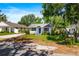 Charming single-story home with a blue front door, white siding, and a well-kept lawn at 716 35Th W St, Bradenton, FL 34205