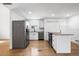Modern kitchen with stainless appliances, white cabinetry, and a stylish island for extra counter space at 716 35Th W St, Bradenton, FL 34205