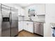 Well-lit kitchen boasts white cabinets, stainless appliances, and granite countertops at 716 35Th W St, Bradenton, FL 34205