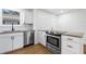 Kitchen featuring white cabinets, granite countertops, and stainless appliances at 716 35Th W St, Bradenton, FL 34205
