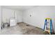 This room features a washer, ladder, and unfinished flooring at 716 35Th W St, Bradenton, FL 34205