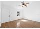 Bright, empty living room featuring hardwood floors, white walls, vaulted ceilings, and ceiling fan at 716 35Th W St, Bradenton, FL 34205
