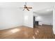 Bright, empty living room featuring hardwood floors, white walls, vaulted ceilings, and ceiling fan at 716 35Th W St, Bradenton, FL 34205