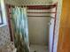 Outdated bathroom featuring a shower with patterned curtains and a tiled walls at 8109 Franklin Rd, Plant City, FL 33565