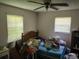 Messy bedroom featuring an unmade bed, cluttered surfaces, and general disarray at 8109 Franklin Rd, Plant City, FL 33565