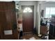 Dark brown front door leading to a cluttered entryway needing repair and organization at 8109 Franklin Rd, Plant City, FL 33565