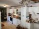 White cabinets in a dated kitchen; needs renovation; appliances and décor needed at 8109 Franklin Rd, Plant City, FL 33565
