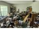 Living room filled with clutter and dated furniture; needs repair and decorating at 8109 Franklin Rd, Plant City, FL 33565