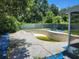 Empty in-ground swimming pool with concrete surround, needing renovation and cleaning, surrounded by a wall at 8109 Franklin Rd, Plant City, FL 33565