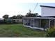 Spacious backyard showcasing a screened lanai, perfect for enjoying the outdoors in comfort at 8274 Rose Ter, Seminole, FL 33777