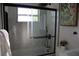Beautiful bathroom featuring a frameless glass shower, matte black fixtures, and tile backsplash at 8274 Rose Ter, Seminole, FL 33777