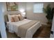 Inviting bedroom featuring neutral tones, decorative pillows, a lush plant, and a sunlit window at 8274 Rose Ter, Seminole, FL 33777