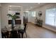 Open concept dining and kitchen area with modern table, stainless appliances, and wood floors at 8274 Rose Ter, Seminole, FL 33777