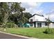 Modern two-story home with black trim, complimented by a well-maintained lawn and mature trees at 8274 Rose Ter, Seminole, FL 33777
