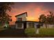 Modern two-story home showcasing a minimalist aesthetic with clean lines and a fresh, inviting black and white exterior at 8274 Rose Ter, Seminole, FL 33777