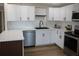 Bright, modern kitchen with stainless steel appliances and white cabinets, offering ample space at 8274 Rose Ter, Seminole, FL 33777