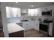 Kitchen featuring white cabinets, stainless steel appliances, modern countertops, and stylish finishes at 8274 Rose Ter, Seminole, FL 33777