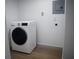 A modern, front-load washing machine is present in the laundry room with essential utilities at 8274 Rose Ter, Seminole, FL 33777