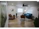 Inviting living room with hardwood floors, modern furniture, natural light, and ceiling fan at 8274 Rose Ter, Seminole, FL 33777