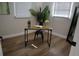 Bright office space featuring a wooden desk, black accents, neutral walls, and plenty of natural light at 8274 Rose Ter, Seminole, FL 33777