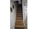 View of the home's wooden staircase with modern railing, leading to the second floor at 8274 Rose Ter, Seminole, FL 33777