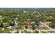 Aerial view of a tree-lined neighborhood showcasing lush landscaping and well-maintained residences at 945 Winding Oaks Dr, Palm Harbor, FL 34683