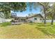 Backyard featuring a concrete patio, hot tub, and basketball hoop at 945 Winding Oaks Dr, Palm Harbor, FL 34683