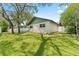 Backyard featuring a large yard and a white fence at 945 Winding Oaks Dr, Palm Harbor, FL 34683