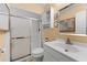 Bathroom featuring a shower with sliding glass doors, white vanity, and neutral wall color at 945 Winding Oaks Dr, Palm Harbor, FL 34683