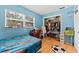 A blue bedroom with hardwood floors and a walk in closet at 945 Winding Oaks Dr, Palm Harbor, FL 34683
