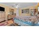 Bright bedroom with wood floors, natural light, dresser, and a ceiling fan at 945 Winding Oaks Dr, Palm Harbor, FL 34683