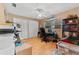 Bright bedroom with neutral walls, wood floor, window and ample workspace at 945 Winding Oaks Dr, Palm Harbor, FL 34683