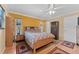 Comfortable bedroom with ceiling fan, wood floors, closet, and windows for natural light at 945 Winding Oaks Dr, Palm Harbor, FL 34683