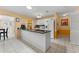 Bright eat-in kitchen features white cabinets, tiled backsplash, and a spacious counter with an island at 945 Winding Oaks Dr, Palm Harbor, FL 34683