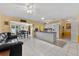 Open concept living area with access to dining area and kitchen with yellow accent wall at 945 Winding Oaks Dr, Palm Harbor, FL 34683