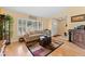 Cozy living room with hardwood floors, neutral paint, and lots of natural light at 945 Winding Oaks Dr, Palm Harbor, FL 34683