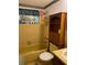 A yellow bathroom with decorative fish themed accents at 9510 Mark Twain Ln, Port Richey, FL 34668