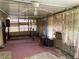 Enclosed back porch with a bed frame and several windows at 9510 Mark Twain Ln, Port Richey, FL 34668