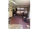 Enclosed back porch with a bed frame and several windows at 9510 Mark Twain Ln, Port Richey, FL 34668
