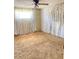 A bedroom with worn brown carpet and floral wallpaper at 9510 Mark Twain Ln, Port Richey, FL 34668