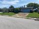 Quaint single-story home with a front lawn and an attached garage at 9510 Mark Twain Ln, Port Richey, FL 34668