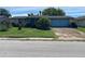 Charming single-story home with a front lawn and an attached garage at 9510 Mark Twain Ln, Port Richey, FL 34668