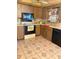 Functional kitchen with appliances, tile backsplash, and patterned tile flooring at 9510 Mark Twain Ln, Port Richey, FL 34668