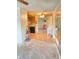Spacious living room with outdated flooring and plenty of natural light at 9510 Mark Twain Ln, Port Richey, FL 34668