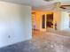 Open-concept living room with outdated flooring and lots of potential for renovation at 9510 Mark Twain Ln, Port Richey, FL 34668