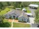 Aerial view of the charming single-story home with a well-kept lawn and ample parking at 23268 Family Ln, Brooksville, FL 34602