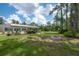 Spacious backyard featuring a fire pit and covered seating areas at 23268 Family Ln, Brooksville, FL 34602