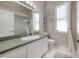 Well lit bathroom with a large vanity, decorative mirror, and neutral color palette at 23268 Family Ln, Brooksville, FL 34602